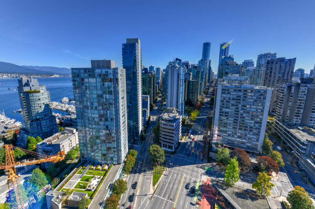 Aerial view of the modern city skyline of Vancouver, British Columbia, Canada during a sunny day.